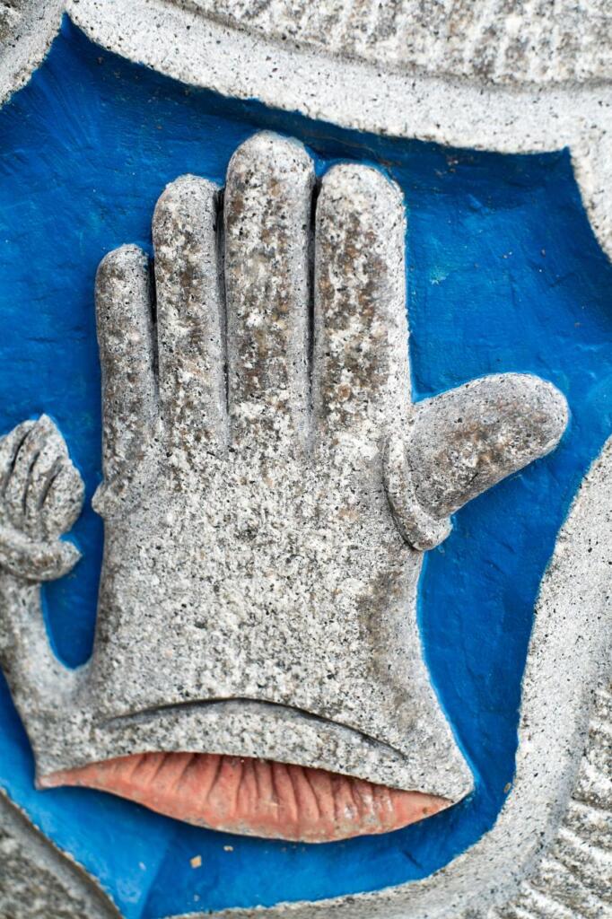Blau-Silbernes Handschuh-Wappen in Stein.
