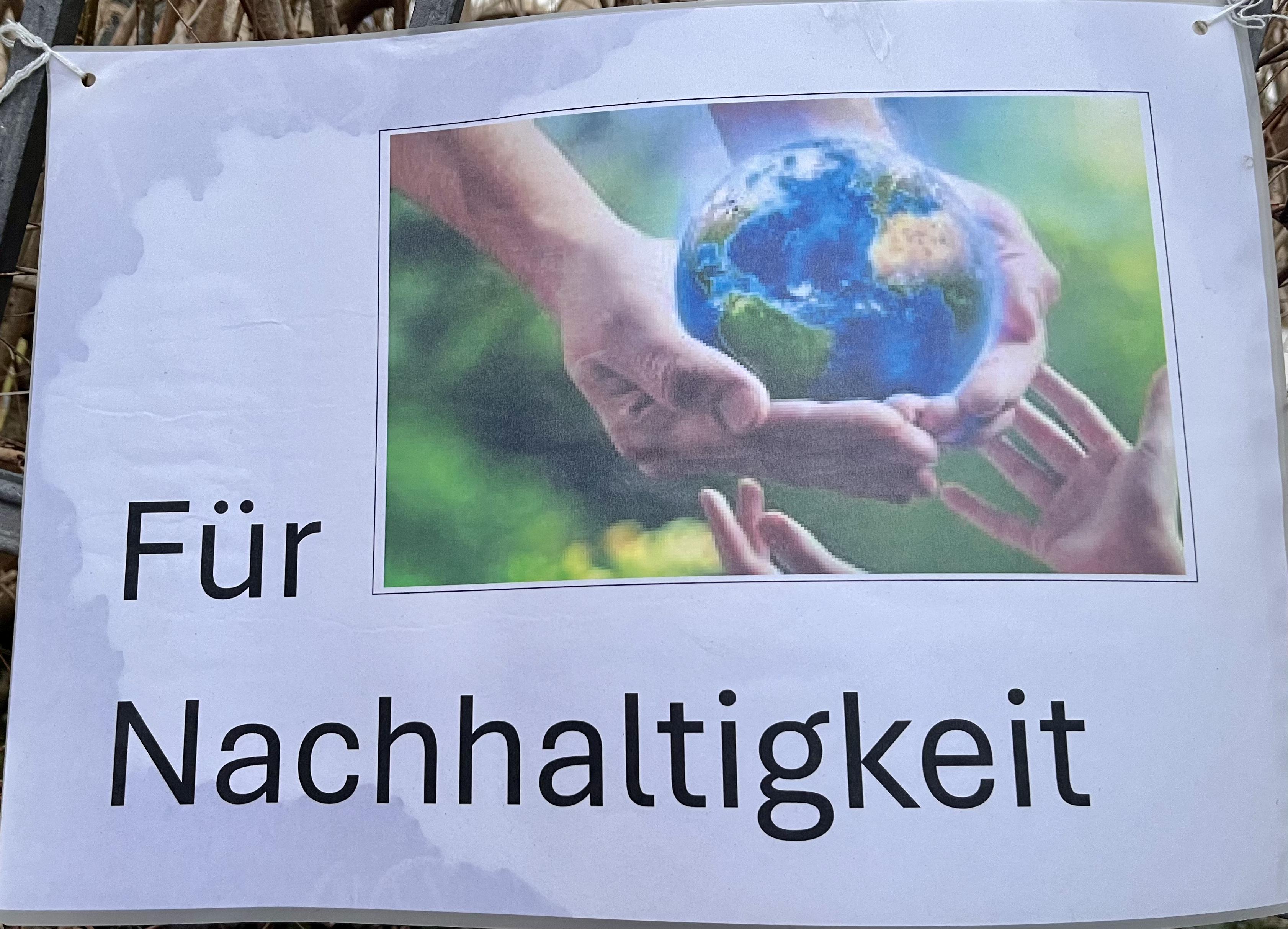Plakat mit der Aufschrift "Für Nachhaltigkeit", ein Schmuckbild verdeutlicht diesen Text.